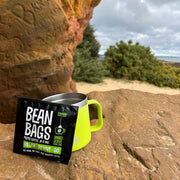 An individually wrapped "Relax Revive Go" coffee bag on Agglestone Rock in South Dorset. Raw Bean Bean Bags are biodegradable, pyramid shaped coffee bags packed with 100% Arabica coffee "Proper Coffee in a Bag". Photo credit: Jim Hart