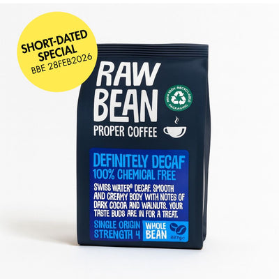 Short dated special label BBE 28FEB2026 on a bag of Raw Bean Proper Coffee, Definitely Decaffeinated, Swiss Water Process, Medium Roast, Coffee Beans. The bag is 227g and made of recyclable material.
