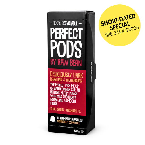 A pack of Deliciously Dark Perfect Pods by Raw Bean, featuring a yellow circular badge reading 'Short-Dated Special: Best Before 31OCT2026'. The packaging is black and burgundy with white and red text, highlighting the Brazilian and Nicaraguan blend and 100% recyclable aluminium capsules.