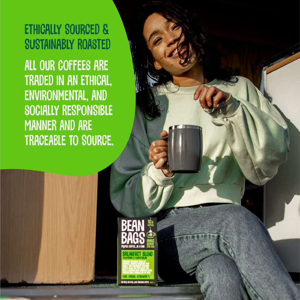 Smiling woman holding a mug beside a Breakfast Blend Bean Bags box, with ethically sourced message