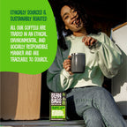 Smiling woman holding a mug beside a Breakfast Blend Bean Bags box, with ethically sourced message