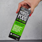 Manicured hand picking up a pack of Raw Bean Perfect Pods Breakfast Blend. 100% Arabica Colombian and Guatemalan coffee blend. 10 Aluminium Capsules Nespresso compatible. 
