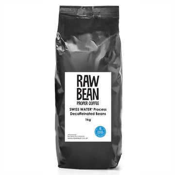 bag of swiss water decaf coffee beans in a black bag with a white raw bean label